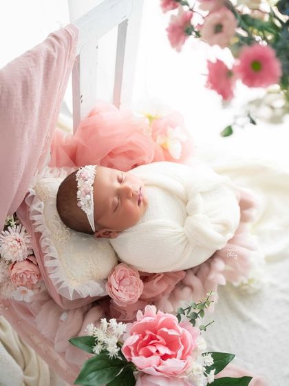 Nestled in a bed of blush pink florals, this baby girl looks like a tiny princess. I use layers of soft fabrics and flowers to create a dreamy, feminine feel.