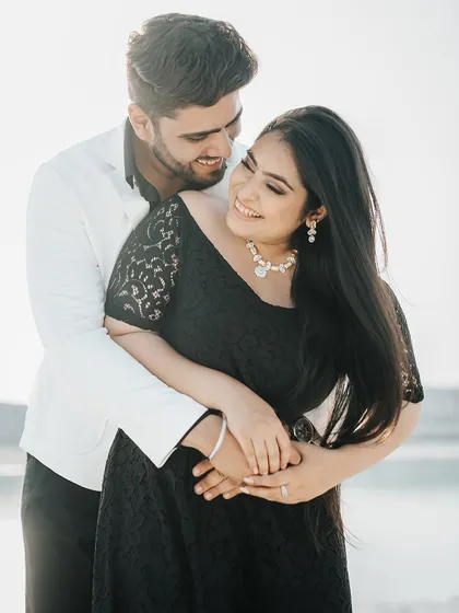 A beautiful, happy portrait of the couple in a warm embrace, showcasing their natural chemistry and love.