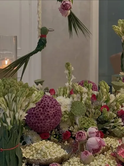 A Diwali tablescape featuring fragrant tuberoses, lotus pods, and bowls of fresh mogra. The design is a beautiful blend of traditional Indian flowers, creating a serene and auspicious setting.
