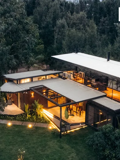 This aerial view showcases a 2BHK cargo home we built, demonstrating how multiple container units can be seamlessly integrated into a larger, cohesive design. The layout includes expansive decks and thoughtful landscaping, creating a complete hospitality experience that feels both private and connected to nature.