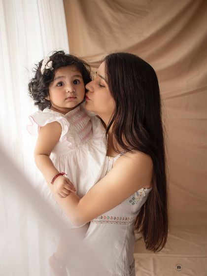 A tender moment between a mother and her baby girl. The soft, natural light and earthy tones create a warm and intimate feel.