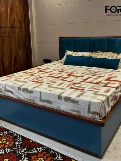 We also create fully integrated bedroom environments, where the wardrobe complements the entire furniture set. This project showcases a dark wood grain wardrobe paired with a custom-designed bed and headboard for a cohesive and luxurious feel.