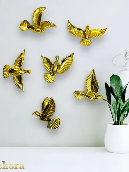 This set of golden birds in flight allows for a creative and personalized wall arrangement. Each bird is individually crafted, giving you the freedom to create a sense of movement and grace on any wall in your home or office.