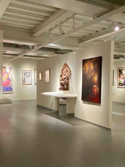 A long view through a gallery at the Museum of Art and Photography (MAP), showing how spaces flow into one another. The design encourages exploration and allows for multiple pathways through the museum's collection.