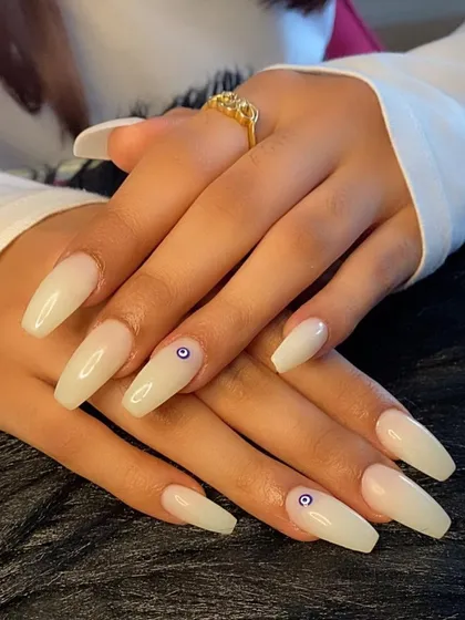 The full set of the minimalist evil eye manicure on long coffin nails.