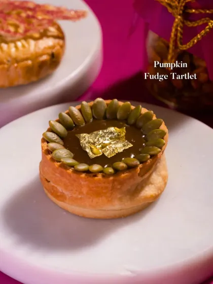 My luxurious Pumpkin Fudge Tartlet. The rich, spiced pumpkin fudge is garnished with pumpkin seeds and a delicate sheet of edible gold leaf, making it a perfect festive treat.