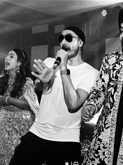 An unforgettable performance. The bride and groom dance alongside singer Sukhbir, creating a core memory for themselves and their guests. We specialize in bringing in top-tier entertainment to elevate your celebration.