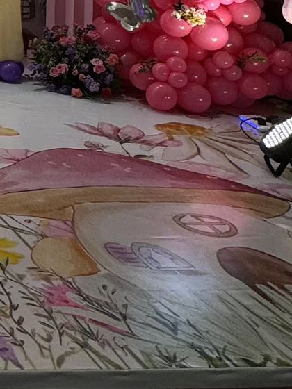 A close up of the custom printed flooring with a spotlight highlighting the mushroom house design.