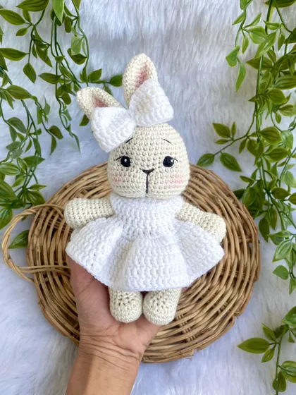 A pure white bunny doll, made as a special gift for a Holy Communion ceremony. Her simple white dress gives her a sacred and peaceful look.