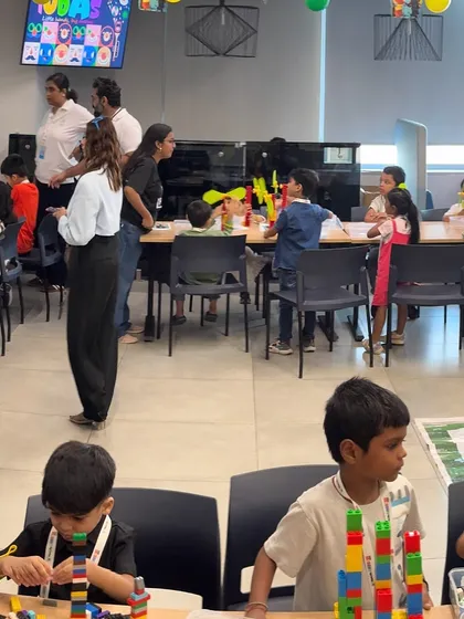 Another view of the bustling MetLife event, with our mentors actively engaging with children at different activity tables, ensuring everyone is learning and having fun.