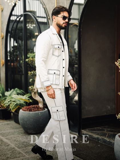 A full-length view of the all-white co-ord set with bold contrast stitching. This look is clean, sharp, and designed to make a powerful minimalist statement.