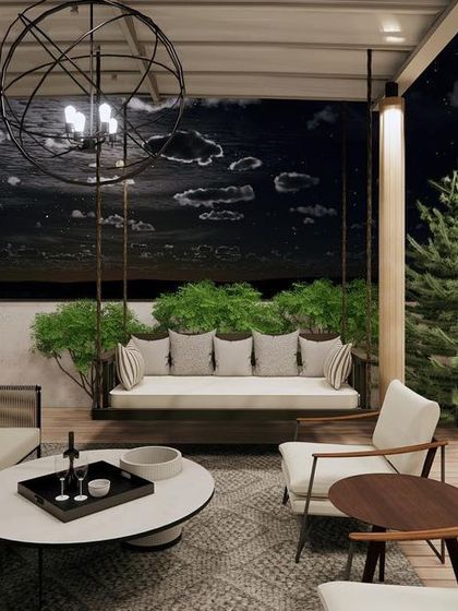 An evening view of a terrace concept, designed for entertaining under the stars. The space includes comfortable sofas, a swing, and plenty of greenery, all lit by a dramatic, spherical chandelier.