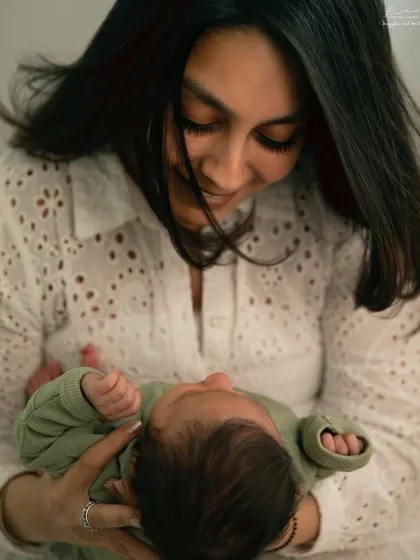 A mother holding her newborn close, her expression full of love. These are the quiet, authentic moments I strive to capture.