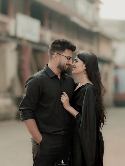 A classic, romantic pose in a narrow city lane. The shallow depth of field blurs the background, making the couple the sole focus.