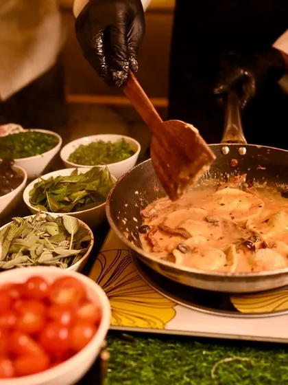 The heart of Italy, served at your party. Our live pasta station in action, where guests watch as we toss fresh ravioli in a creamy, rich sauce. It’s an interactive and delicious element that always delights a crowd.