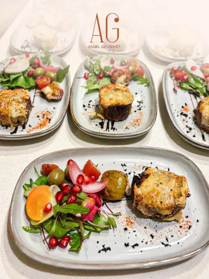 Plated and ready for service, these individual portions of a savory baked dish with a side salad showcase our ability to deliver consistent, high-quality food for events of any size.