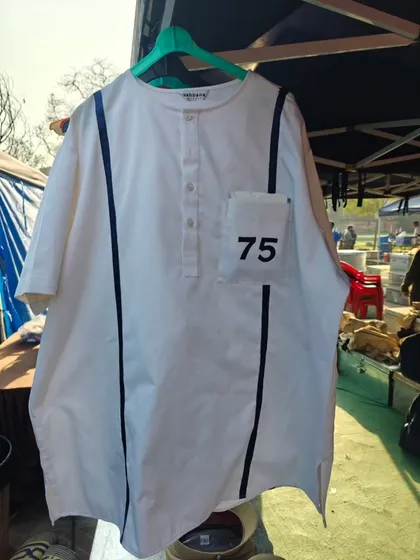 Sometimes a costume is as simple as this. This custom-made shirt with the number '75' was designed for a jail scene, instantly telling the audience the character is a prisoner.