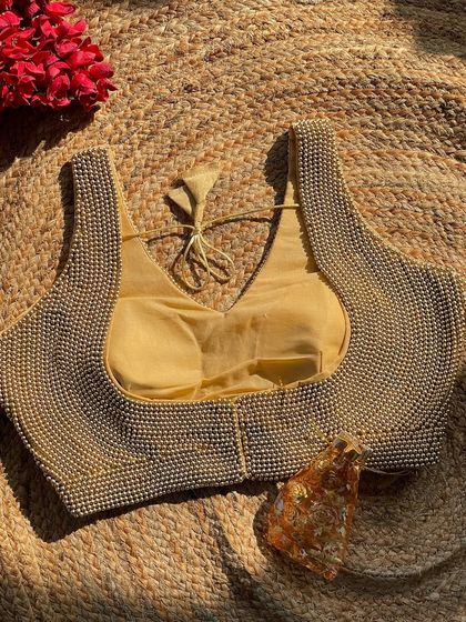 The golden version of the handcrafted pearl blouse, a luxurious choice for weddings and parties.