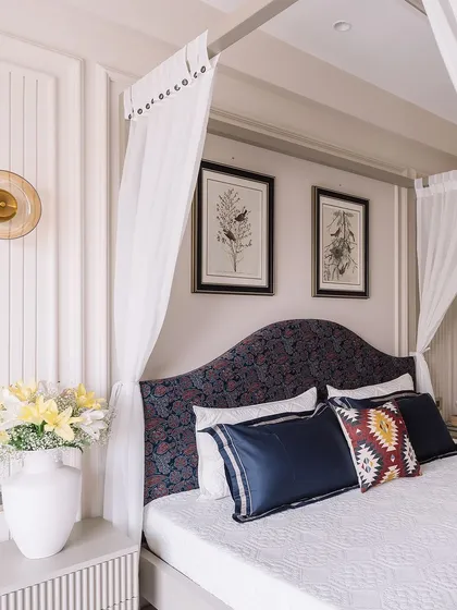 After: The same bedroom reimagined with a four-poster bed, elegant wall paneling, and a curated mix of textures and colors for a sophisticated look.