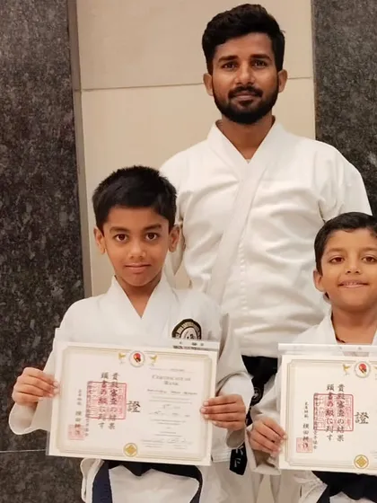 Two more dedicated students proudly displaying their certificates after advancing to the next level. Each belt represents a new chapter in their karate journey, built on perseverance and a commitment to improve.