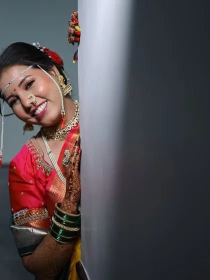 Another angle of the playful peeking shot, showcasing her beautiful smile and radiant makeup.