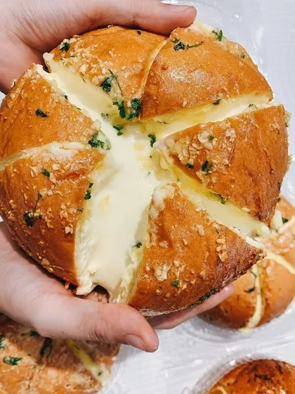 You have to try my savory Korean Cream Cheese Buns. This video shows the soft bun filled with luscious cream cheese, then baked with a garlic butter glaze until golden. It's the ultimate savory treat.