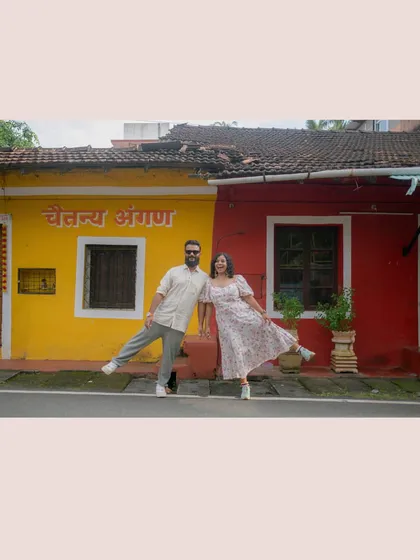 A fun, quirky pose in front of a colorful building in Goa. Their playful energy is infectious, and it shows that pre-wedding shoots are all about having a good time.