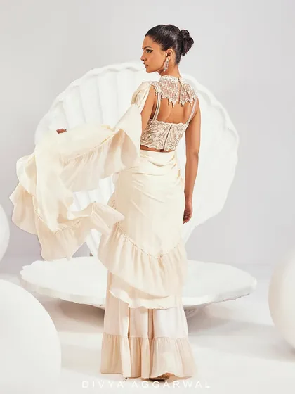 The back view of our Kairi Saree Set, featuring a high-neck embellished blouse and a dramatic ruffled drape.
