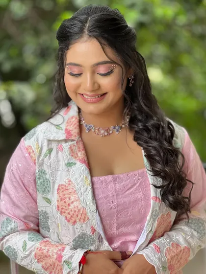 A serene portrait with her eyes closed, showing the beautiful pink-toned eyeshadow.