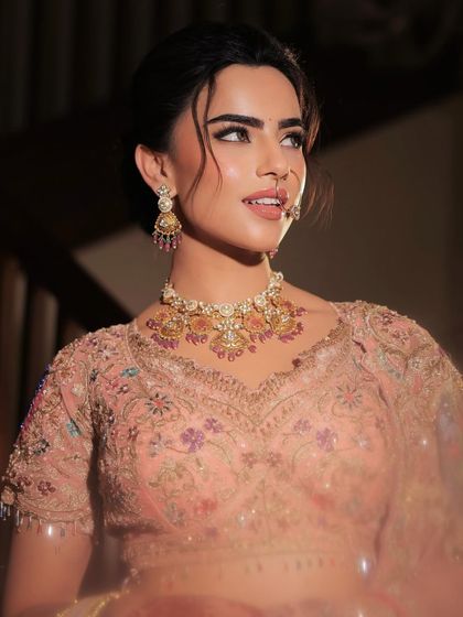 A beautiful portrait of the bride, her expression soft and serene. The makeup enhances her features with a gentle glow and subtle definition.