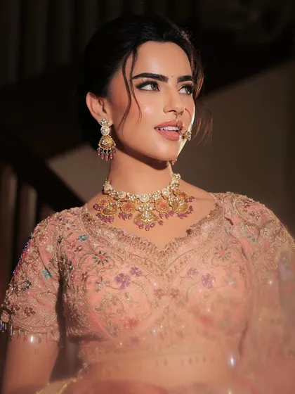 A beautiful portrait of the bride, her expression soft and serene. The makeup enhances her features with a gentle glow and subtle definition.