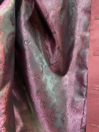 Personalization extends to the smallest details, like the inner lining of your jacket. Here, a vibrant paisley silk lining adds a hidden touch of character to a custom Nehru jacket.