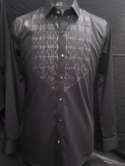 A sleek black designer shirt with a geometric pattern embroidered in silver thread on the chest. This piece redefines sophistication for a formal event or an elegant night out.