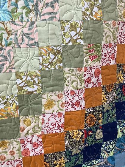A close-up of the gradient patchwork, showing the floral and patterned fabrics.