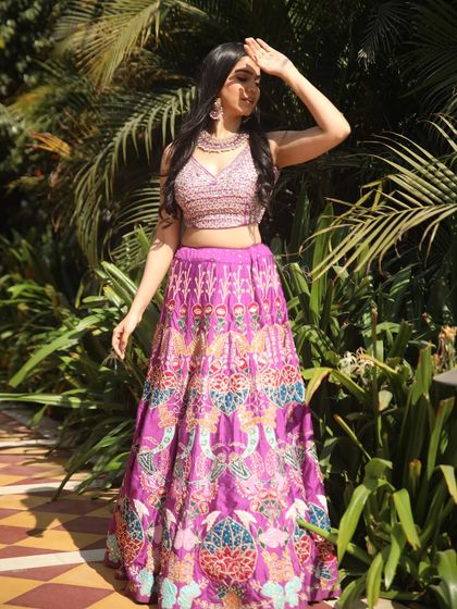 A vibrant purple lehenga perfect for a sunny daytime event. The colourful embroidery is playful and eye-catching.
