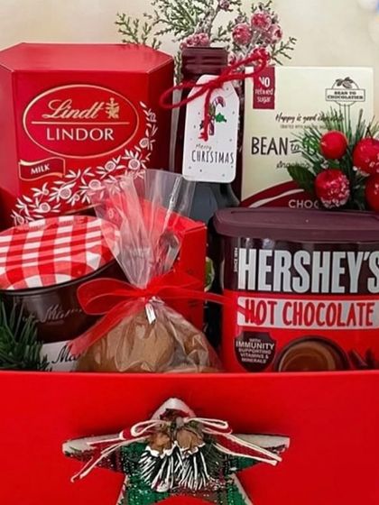 A close-up of our red box Christmas hamper, showing the delicious contents perfect for a cozy winter night.
