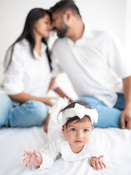 A creative family portrait with the baby in the foreground.