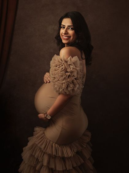 The same gown, styled differently to show its versatility. The mother's joyful expression is the centerpiece of this beautiful shot.