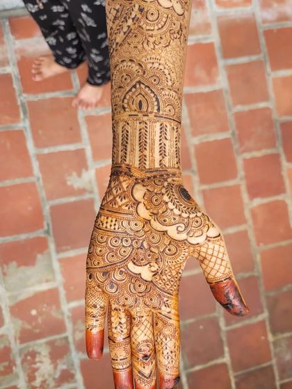 A close-up of a bridal palm design with beautiful swirls and negative space. The contrast between the filled and open areas makes the intricate details pop.