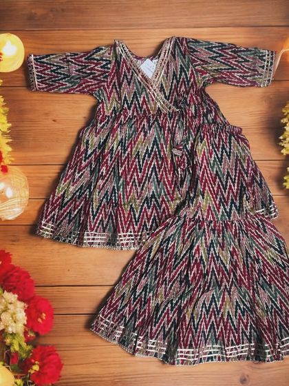 Diwali ready in style! This vibrant cotton Angarkha set features playful zig-zag patterns and chic sharara bottoms, perfect for all the festivities.