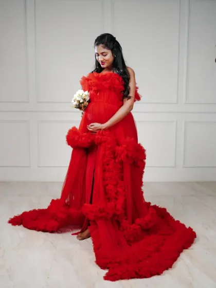 A full-length view of the magnificent red tulle gown, showing off its impressive train and rich color.