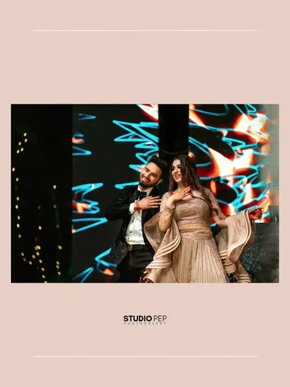 A candid shot of the couple dancing on stage, their joy and energy palpable.