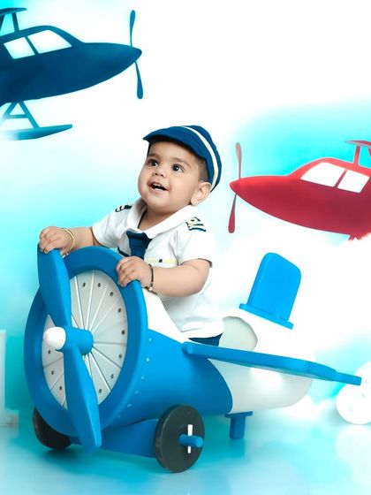 Looking up at the sky, this little pilot is dreaming of his next flight. The airplane theme is a client favorite for adventurous little boys.