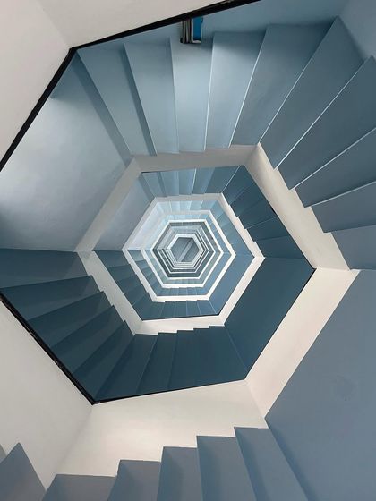 An abstract, mesmerizing shot of a spiral staircase in Pondicherry, showcasing the unique design elements found in the town.
