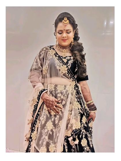 Our client from two years ago sent us this picture, and she still loves her rental outfit. This timeless black velvet lehenga is a classic choice.