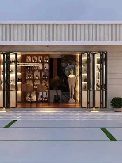A preview of a sophisticated terrace on Golf Course Road, Gurugram. This view shows the seamless connection between an indoor bar area and the expansive outdoor patio, featuring elegant sculptures and a hanging chair for a touch of playful luxury.