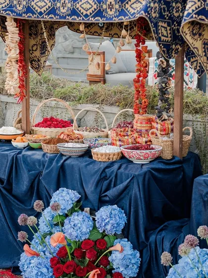 A grand display of local Turkish ingredients and flowers against a deep blue backdrop. This setup served as a stunning welcome for guests at a destination wedding.