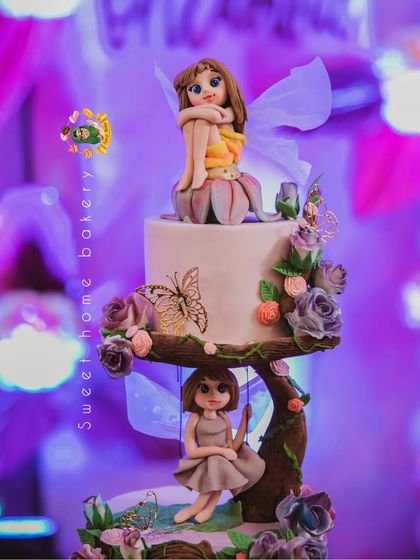 A close-up shot of the beautiful fairy cake, highlighting the delicate wings and the hand-painted butterflies.