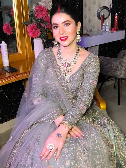 The complete look, showcasing the elegant lehenga and the striking makeup.