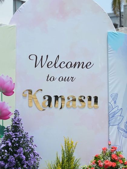 The welcome sign for the "Kanasi" housewarming, surrounded by beautiful fresh flowers. This custom sign was the perfect way to greet guests and celebrate the family's new dream home.